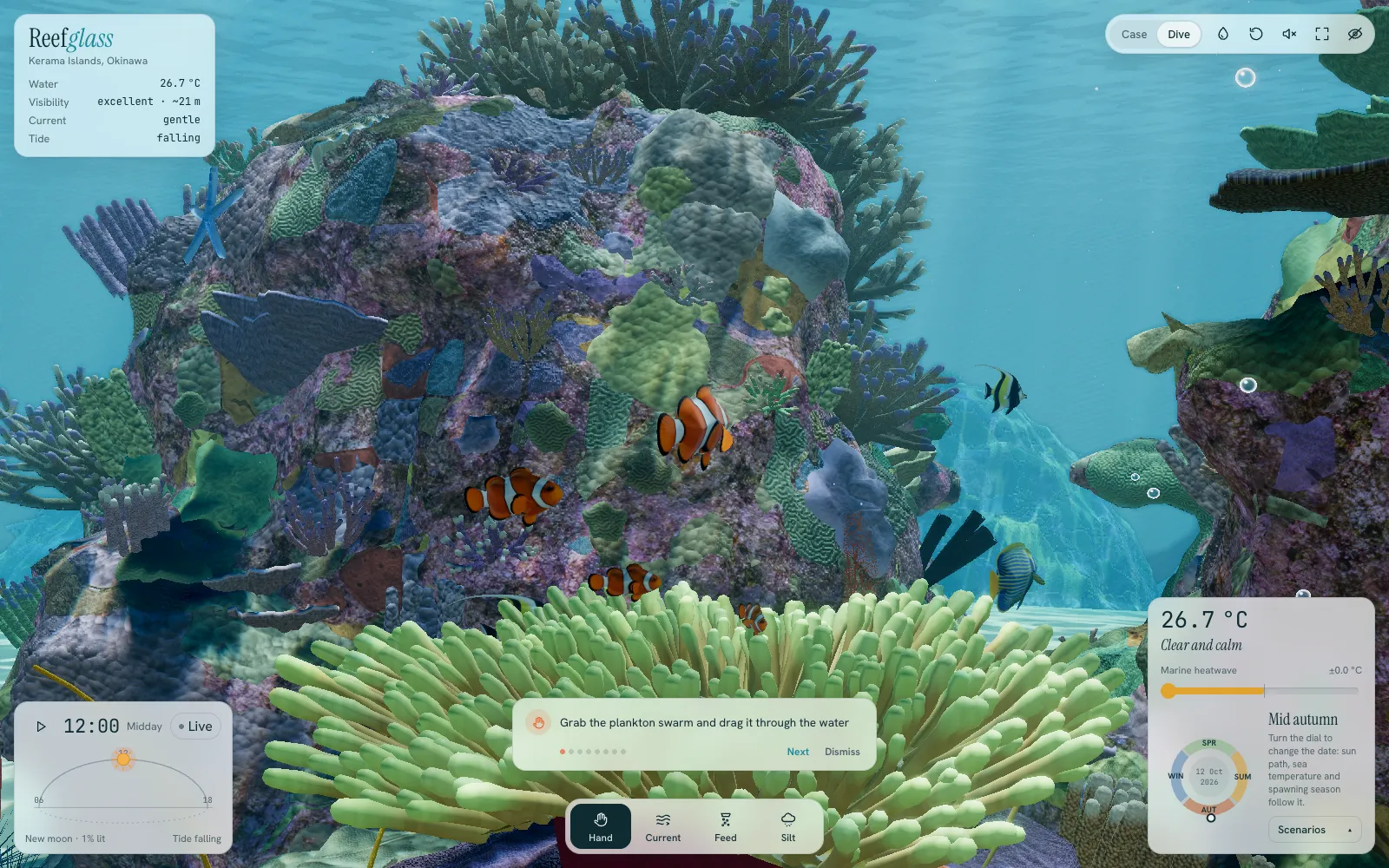 Following a group of ocellaris clownfish over their anemone, beside a coral-covered rock.